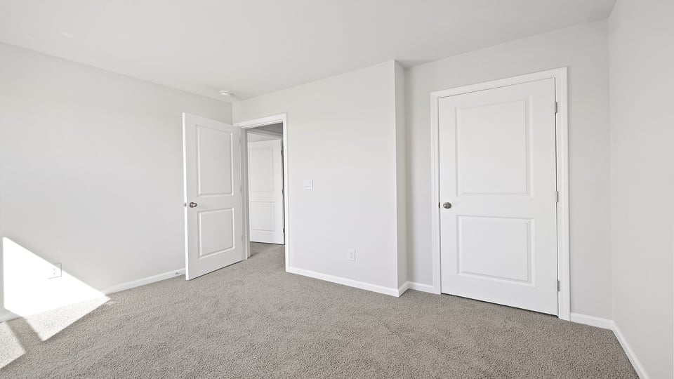 Bedroom with carpet and window.
