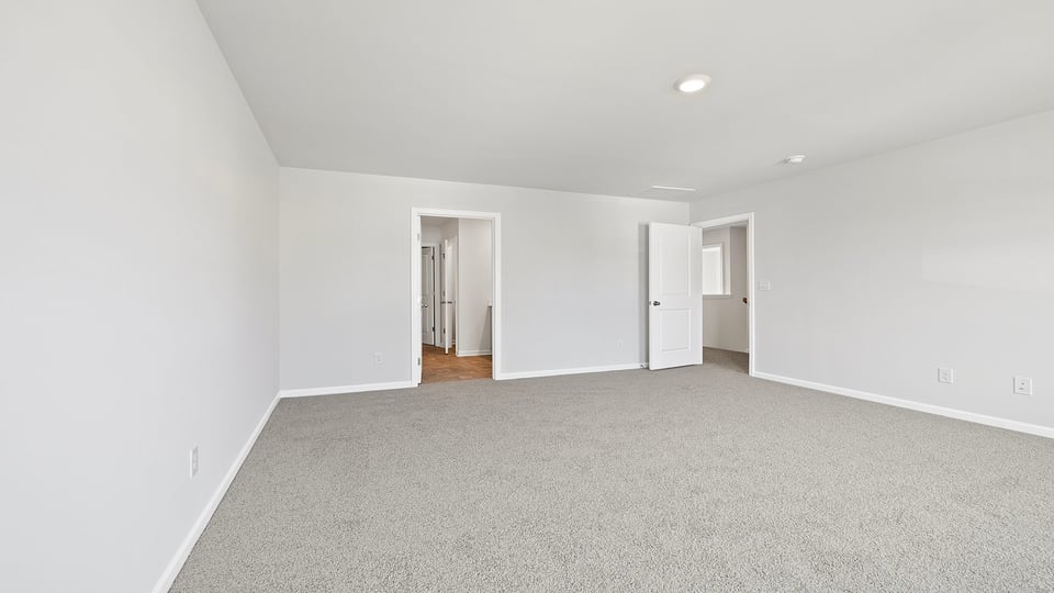 Bedroom with carpet and window.