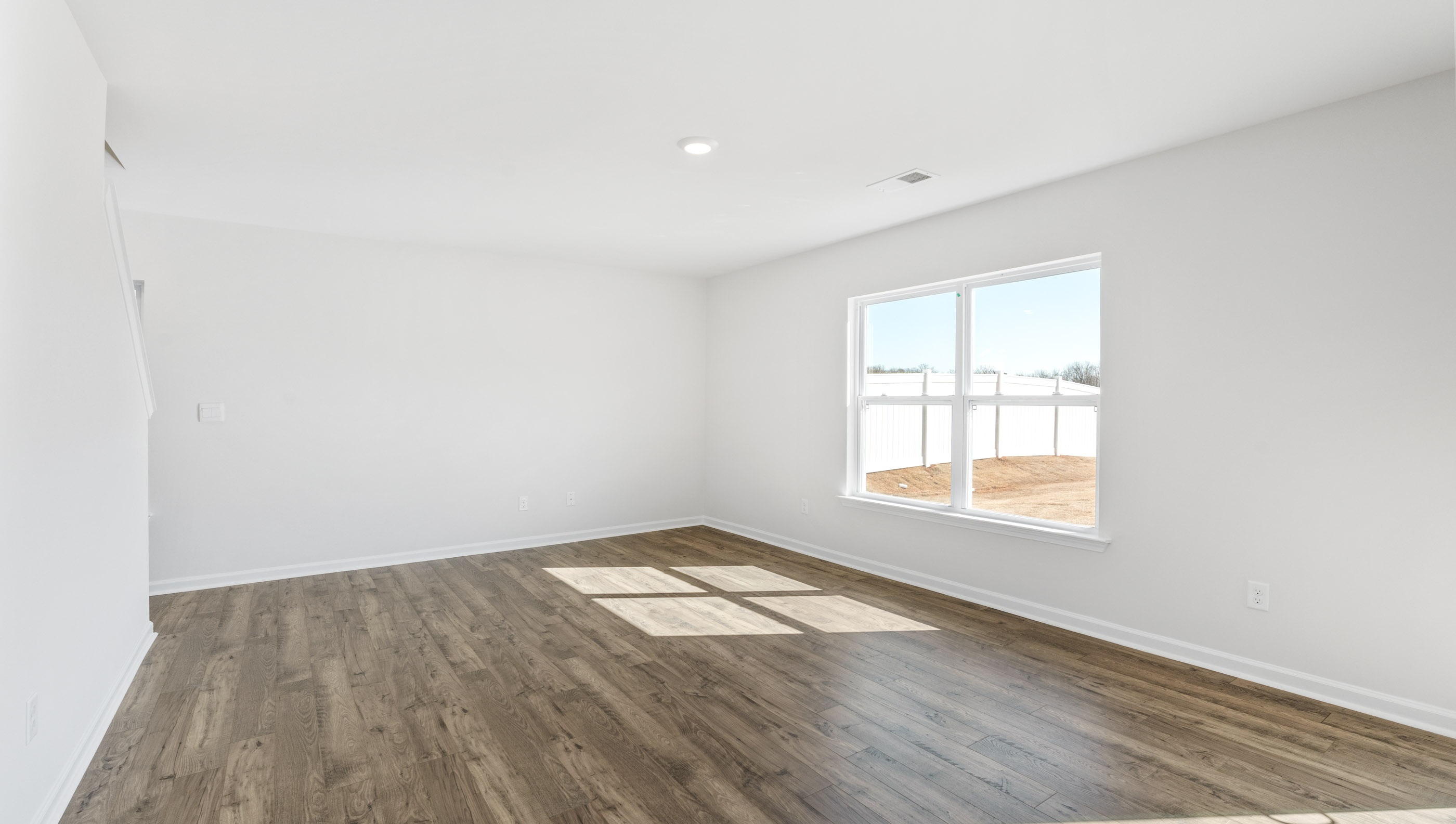 Family room with windows and door to backyard.