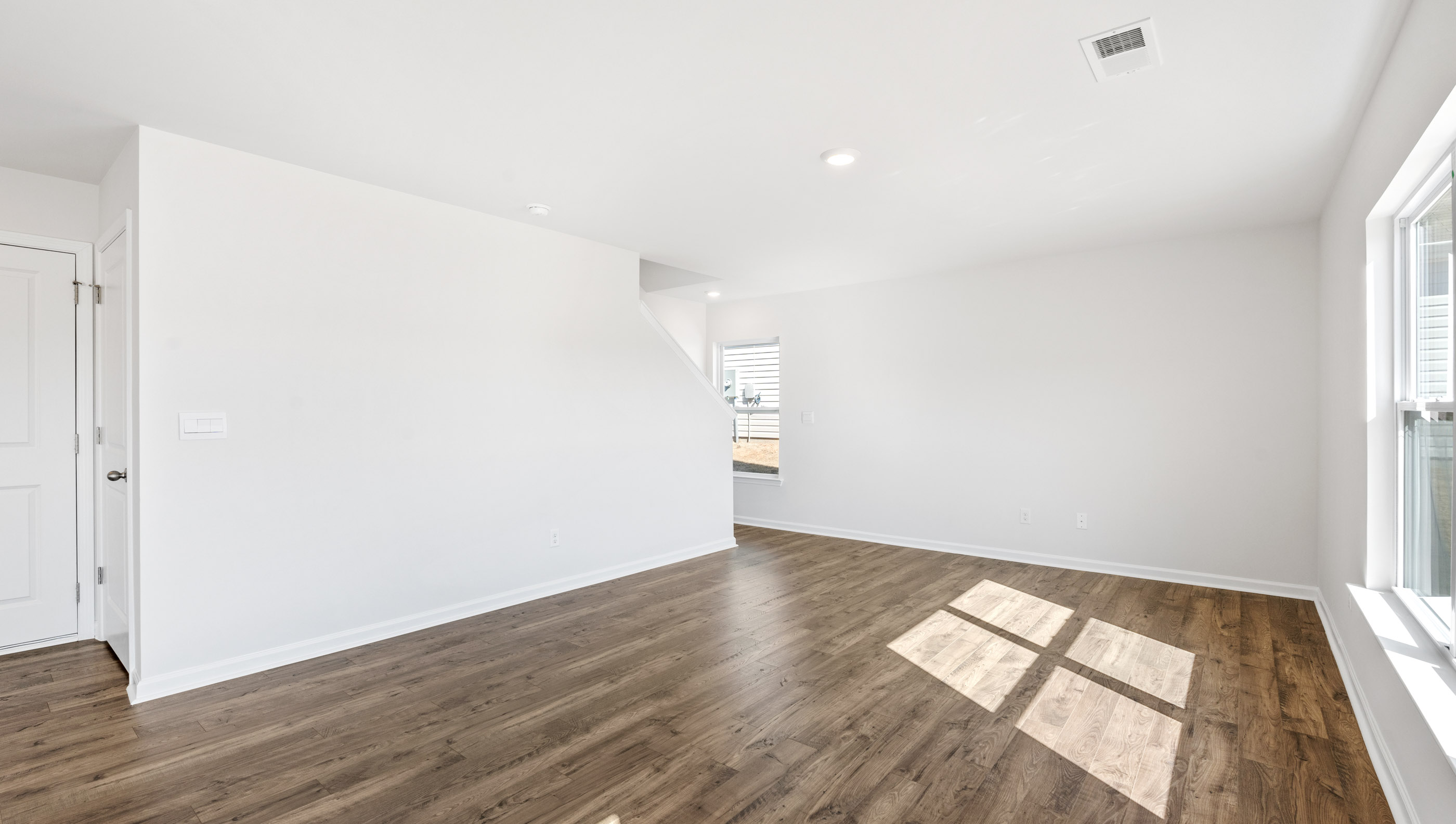 Family room with windows and door to backyard.