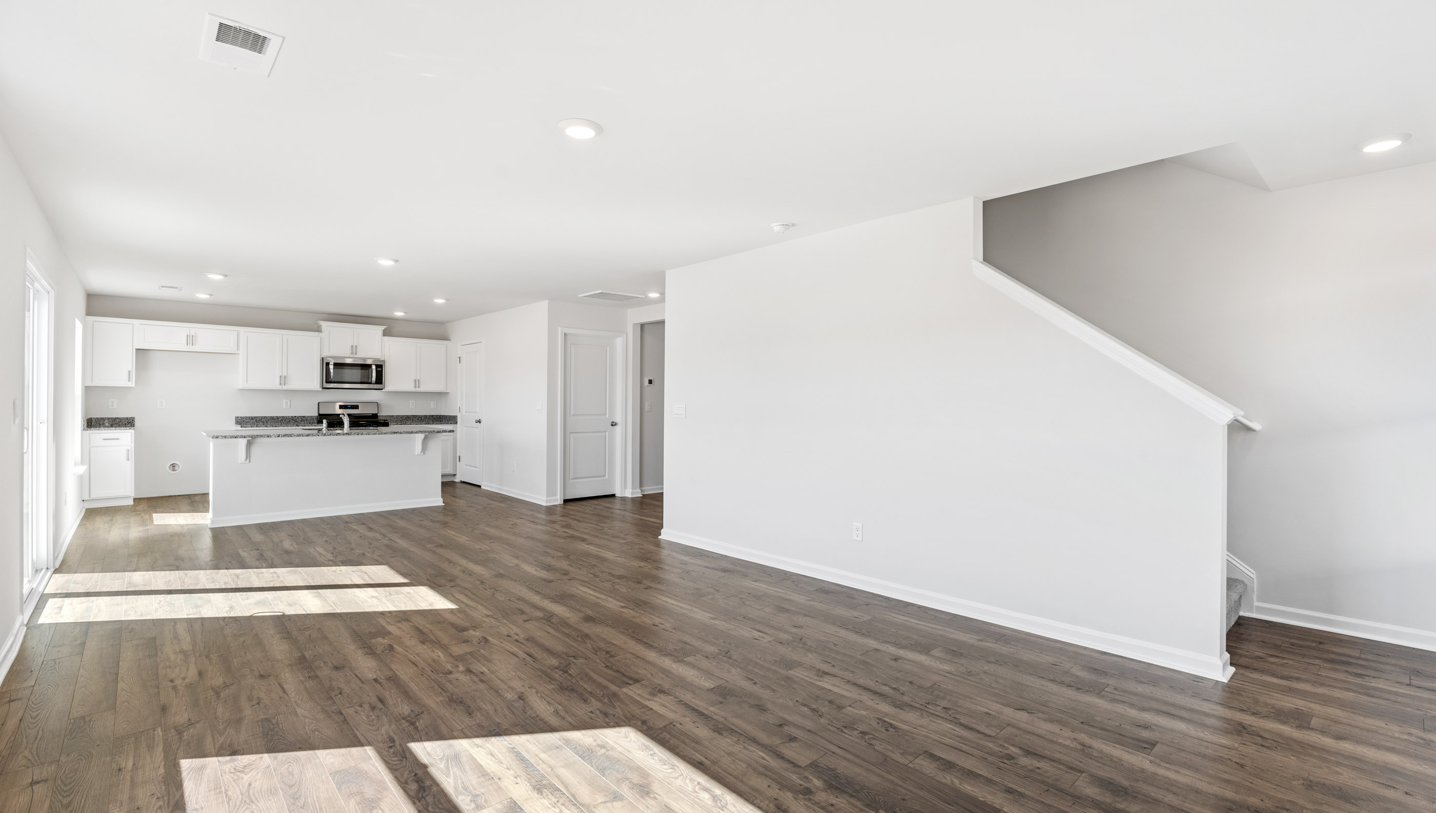 Family room with windows and door to backyard.