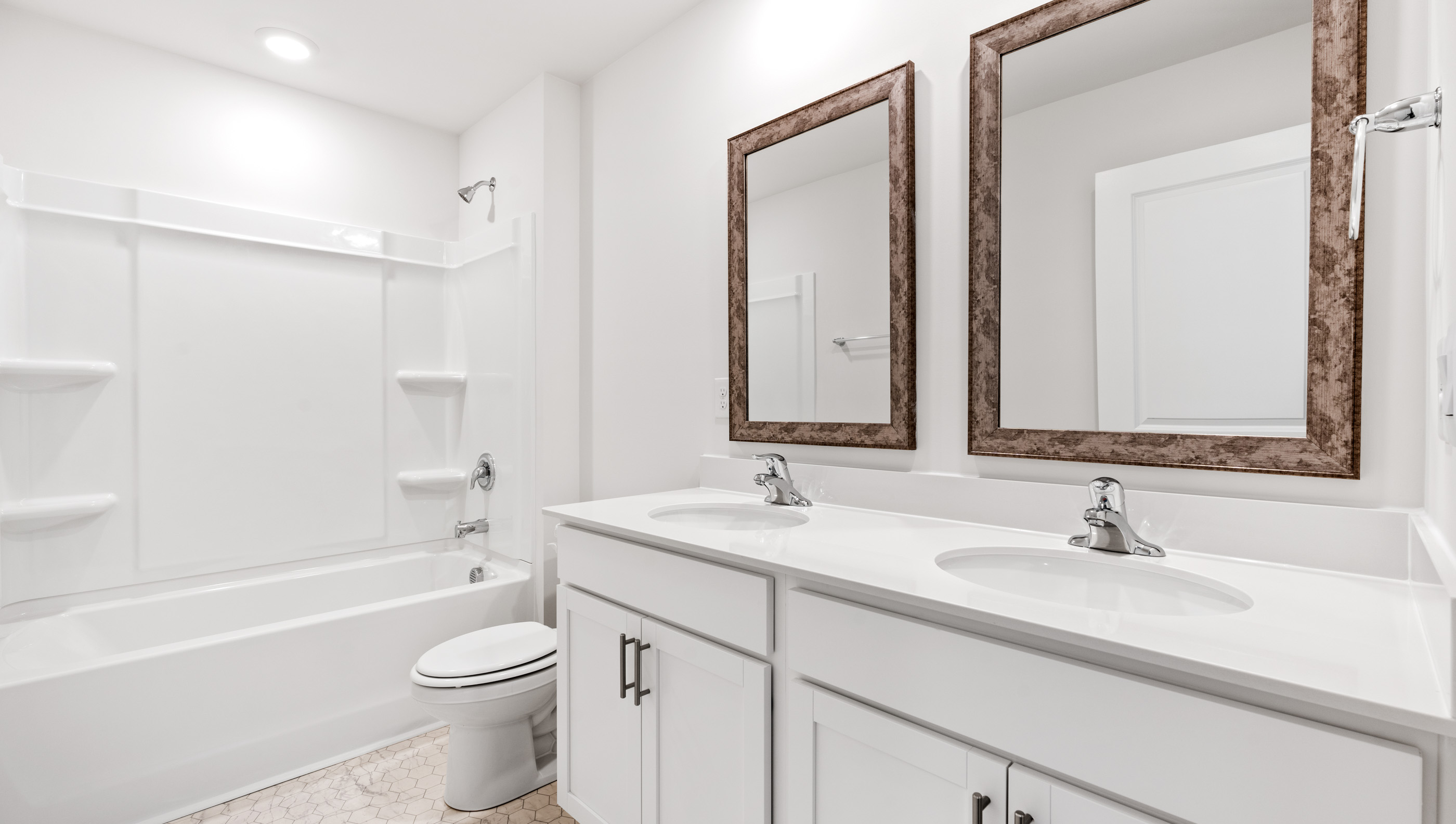 Bathroom with double vanity sink and tub.