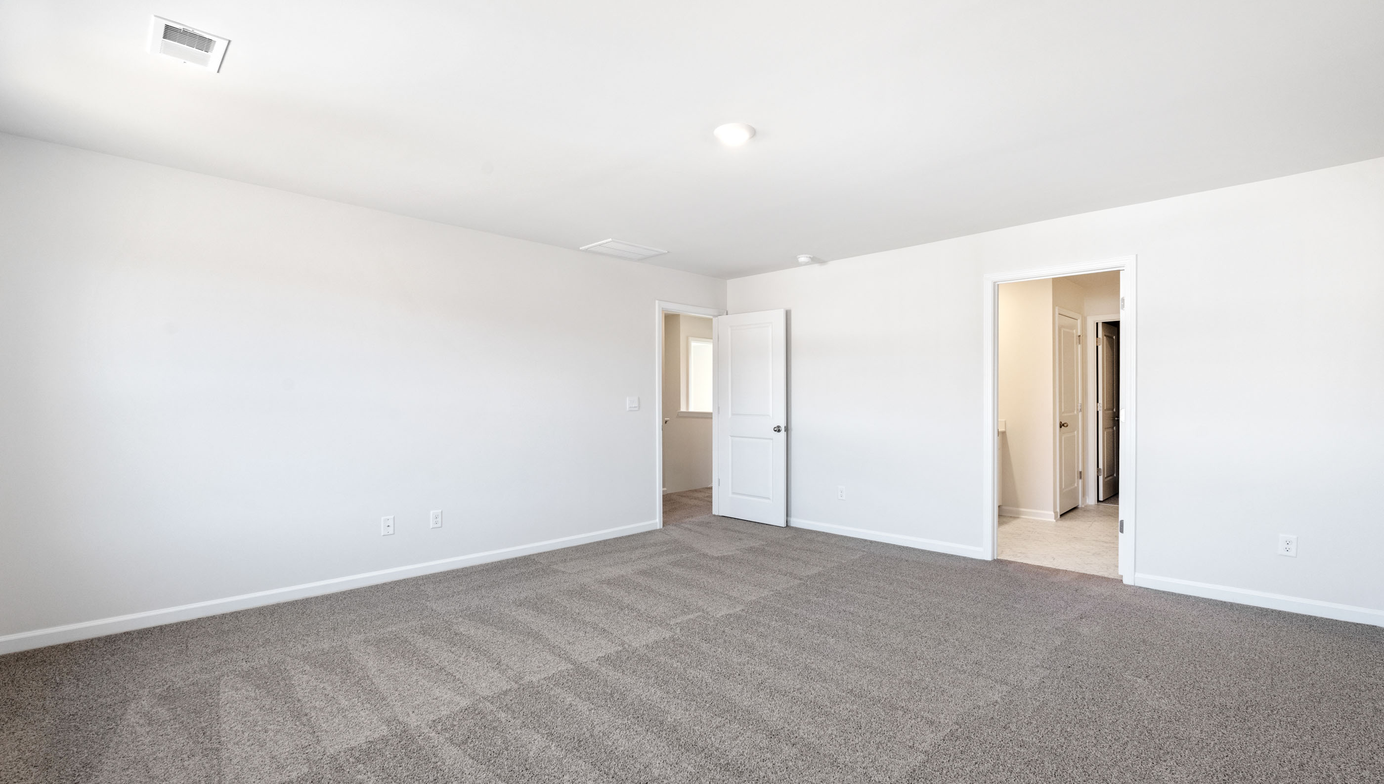 Bedroom with carpet and window.