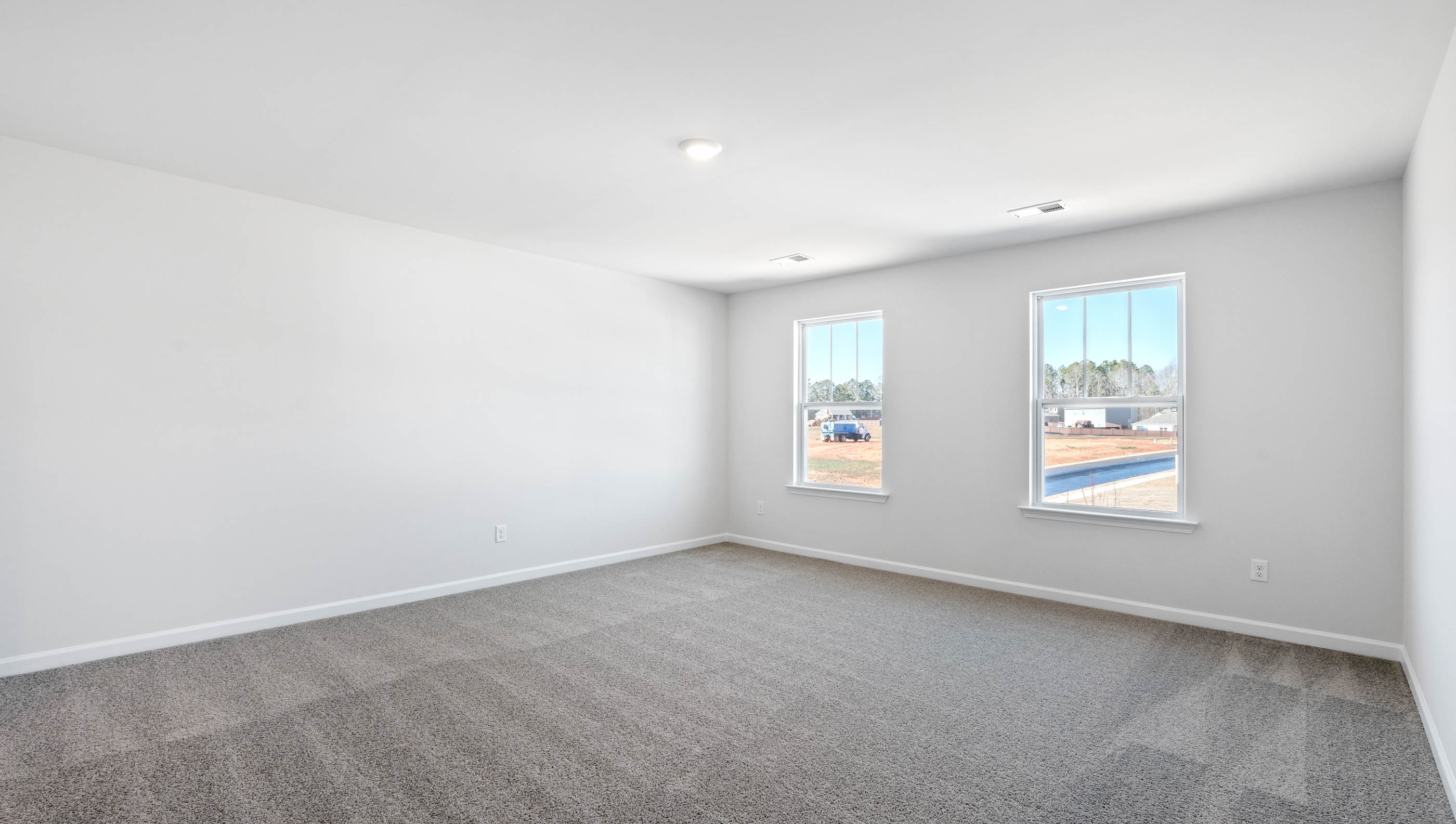 Bedroom with carpet and window.
