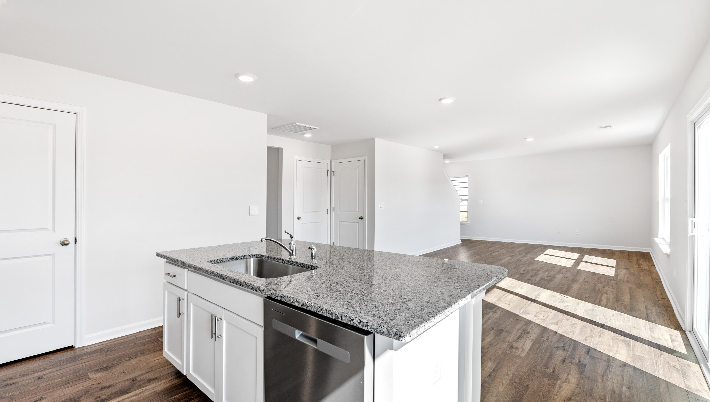 Kitchen and island with granite counter tops.