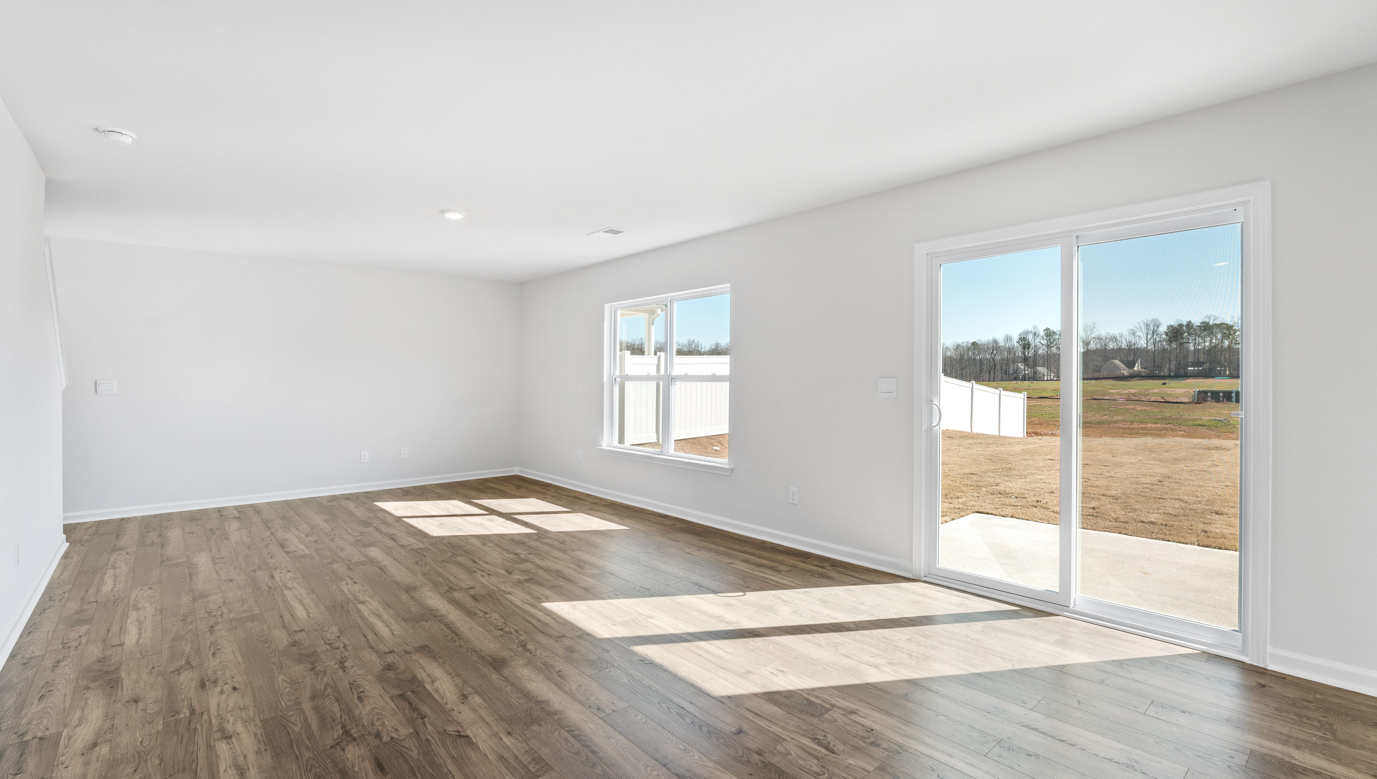 Family room with windows and door to backyard.