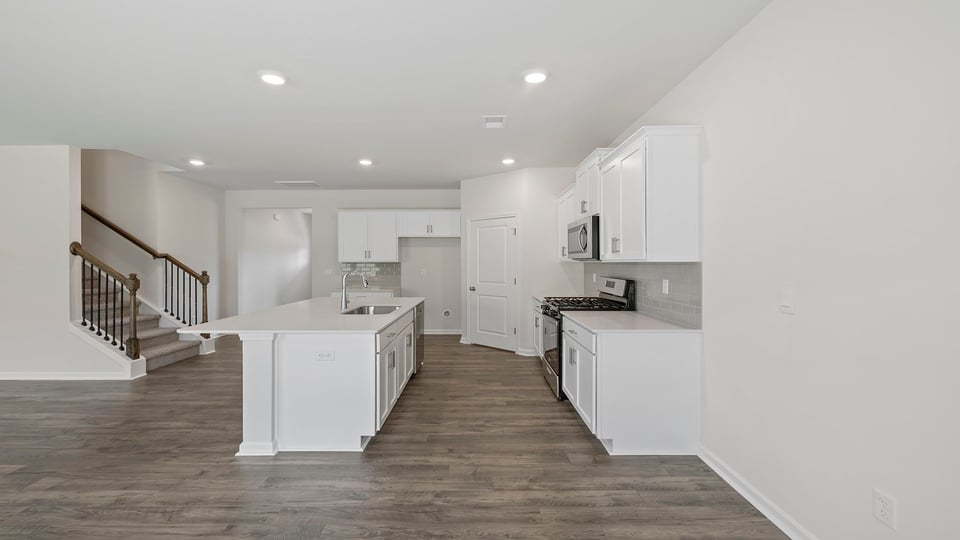 Kitchen and island with granite countertops.