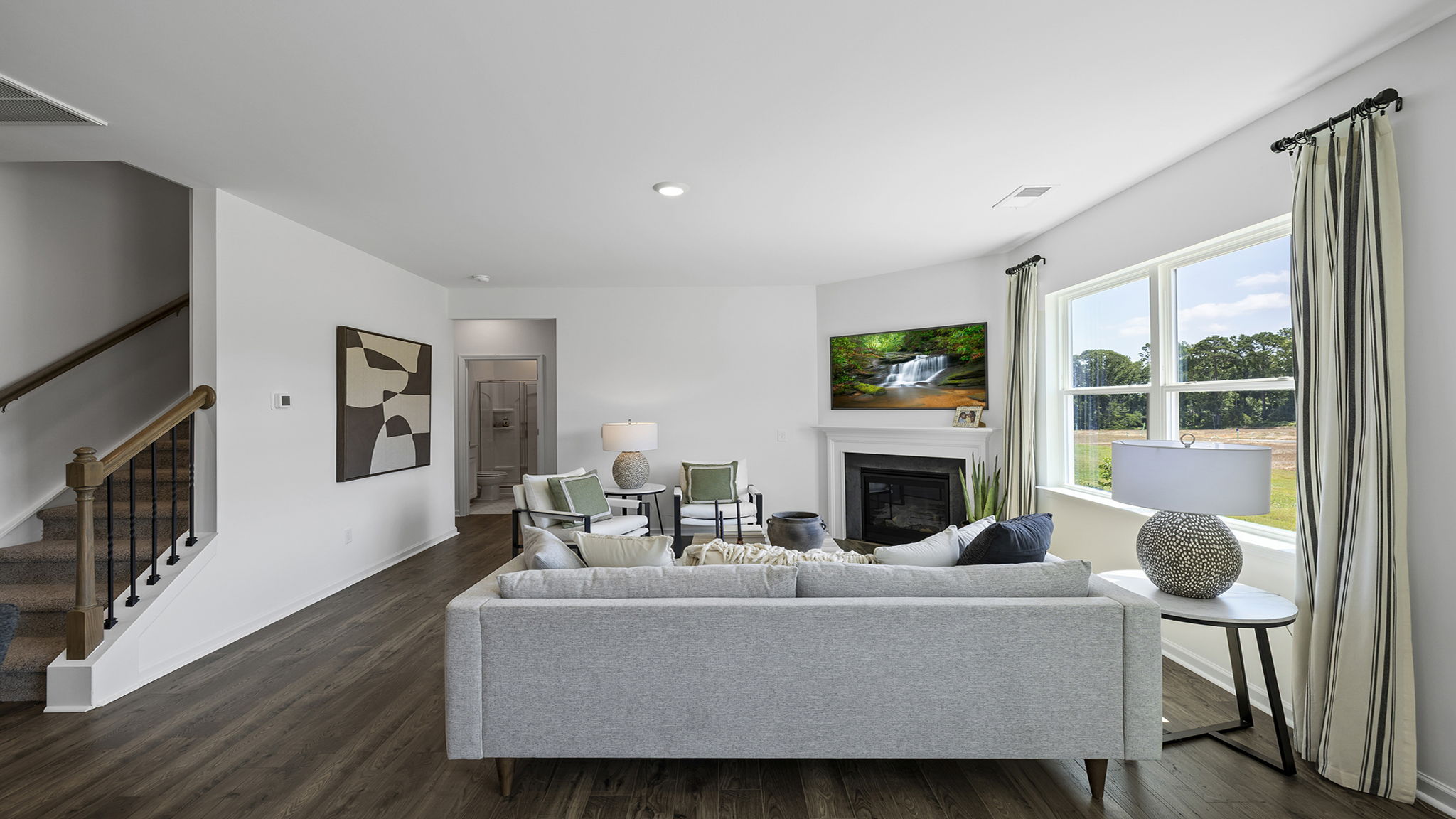Family room with large windows and fireplace.