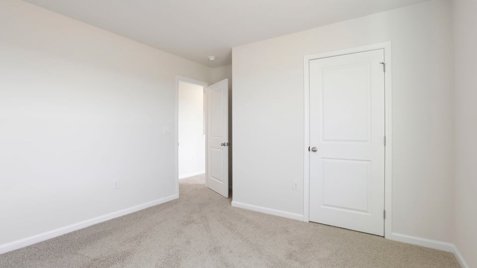 Bedroom with carpet and window.