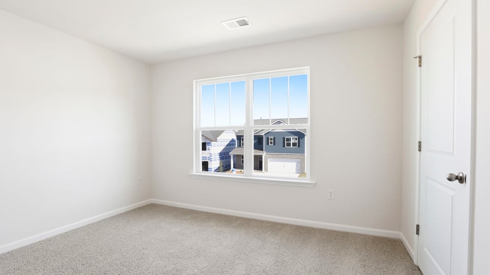Bedroom with carpet and window.