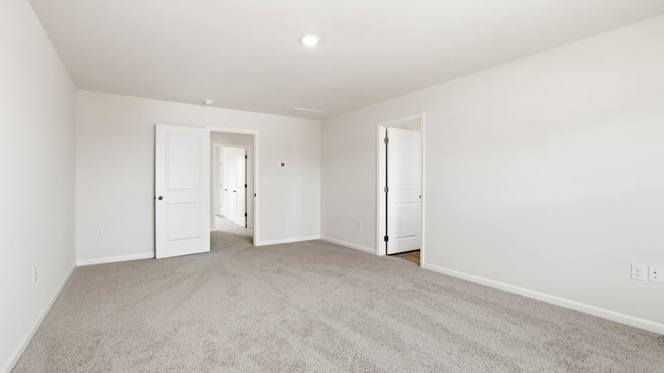 Bedroom with carpet and window.