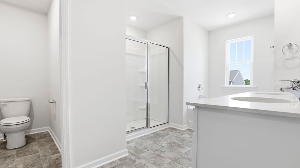Bathroom with vanity and walk in shower.
