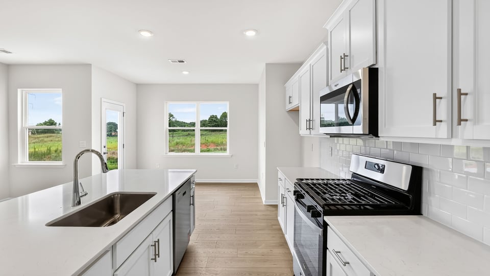 Kitchen view of dining area and windows