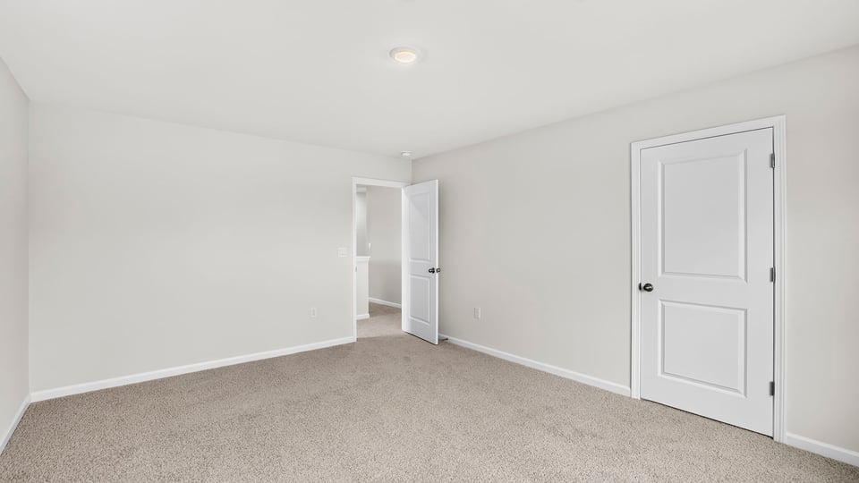 Upstairs bedroom with carpet and closet and door
