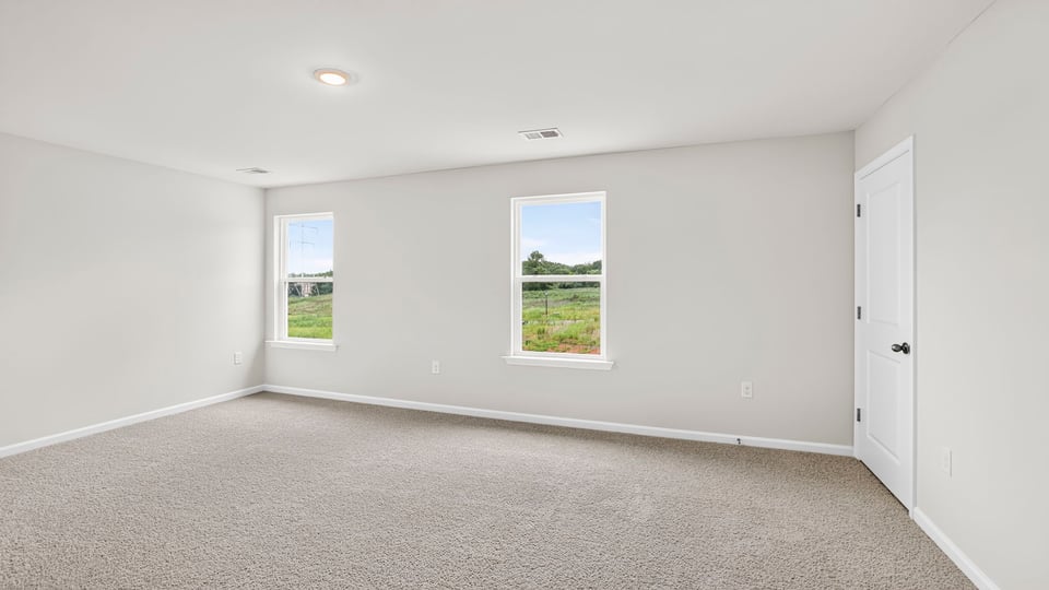 Upstairs bedroom with carpet and windows and closet