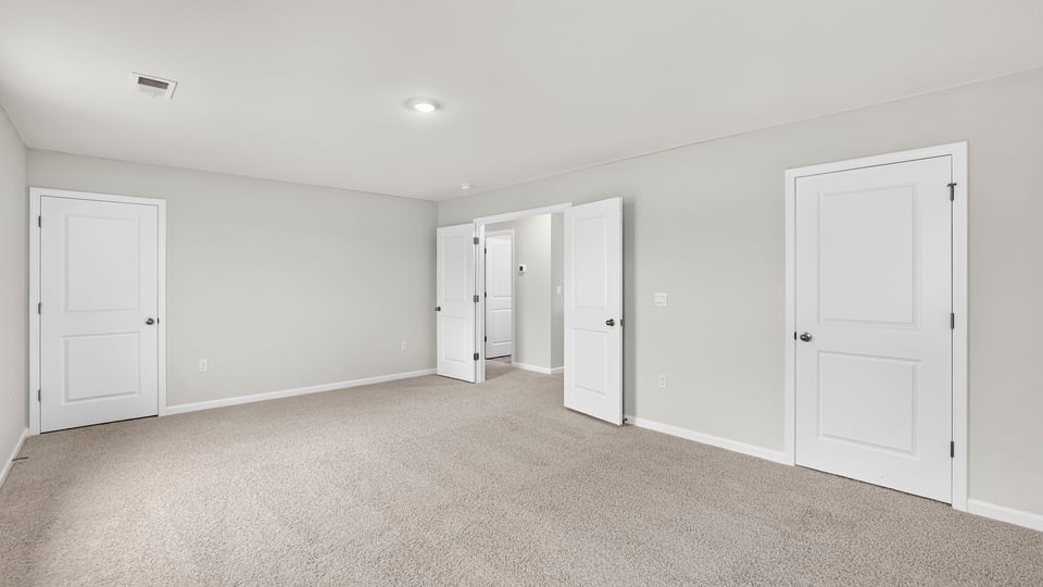 Upstairs bedroom with carpet and closet and double entry doorway