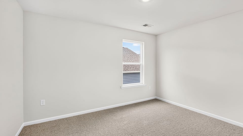 Upstairs bedroom with carpet and window