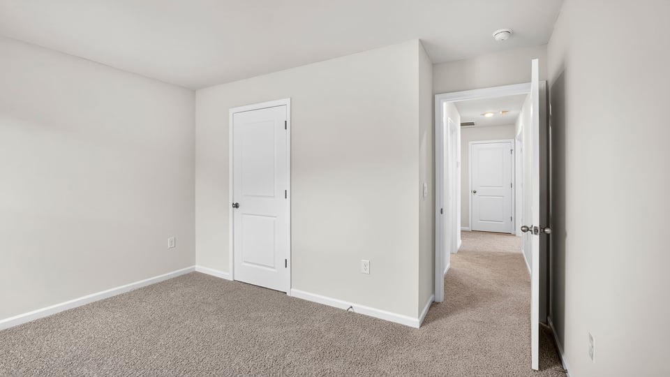 Upstairs bedroom with carpet and closet and doorway