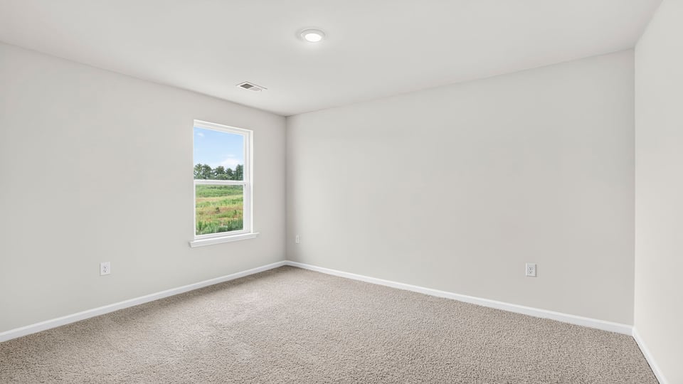 Upstairs bedroom with carpet and window