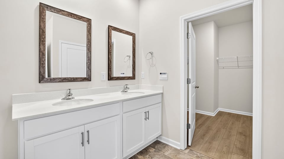 Primary bathroom with double vanity sink and closet