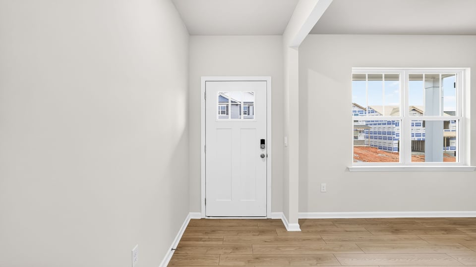 Living area with front door and windows