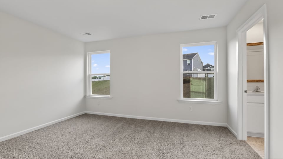 Bedroom with carpet and window.