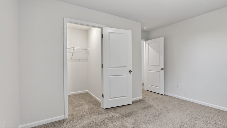 Bedroom with carpet and window.