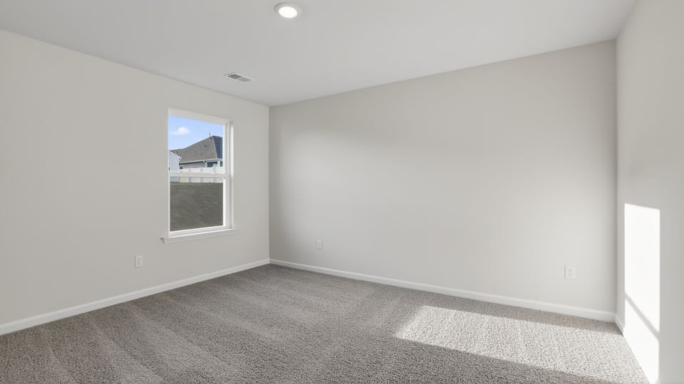 Bedroom with carpet and window.