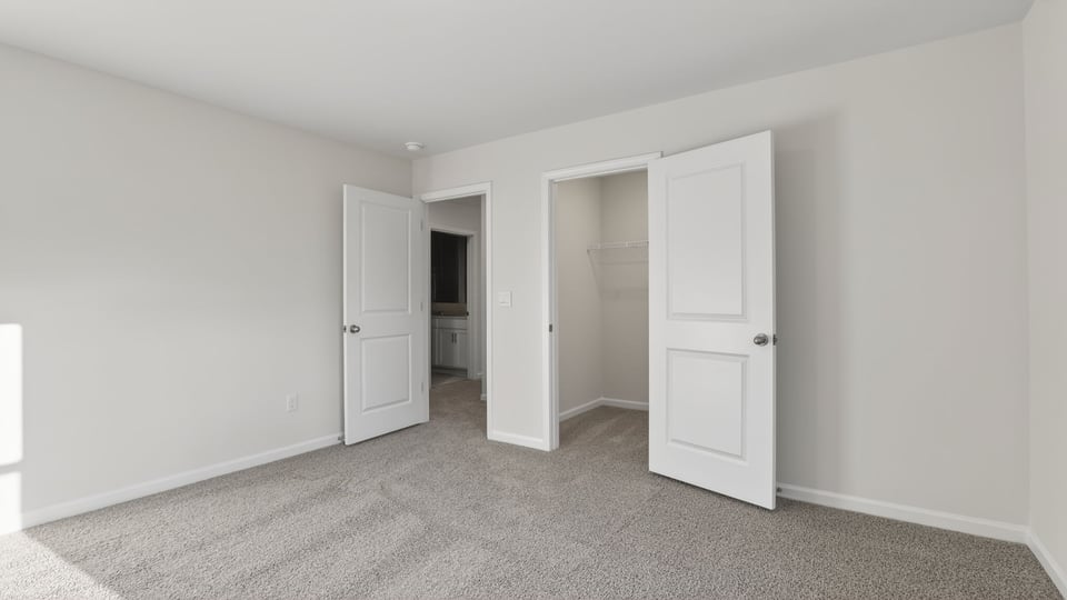 Bedroom with carpet and window.
