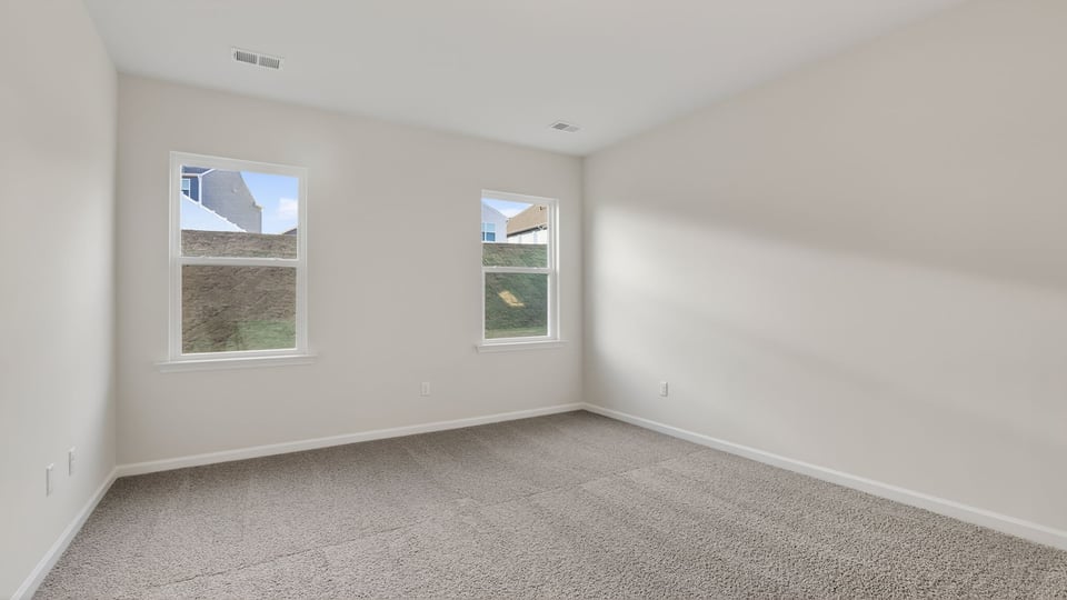 Bedroom with carpet and window.