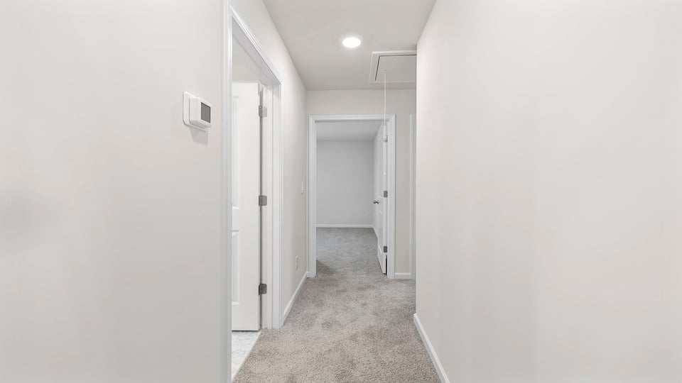 Bedroom with carpet and window.