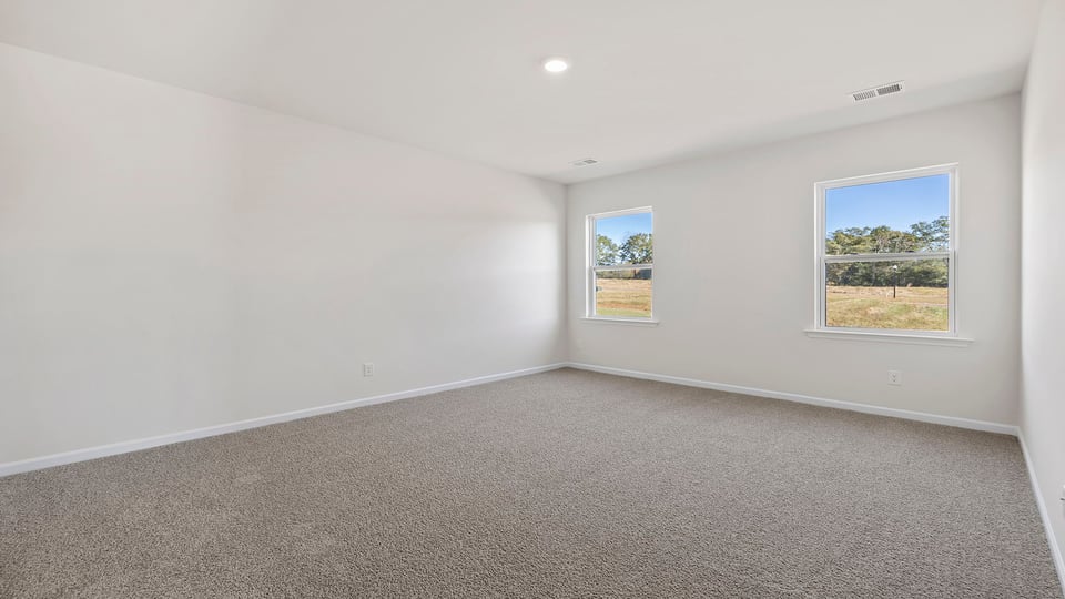 Bedroom with carpet and window.