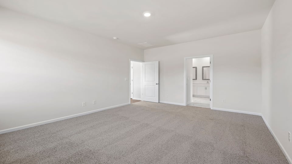 `Bedroom with carpet and window.