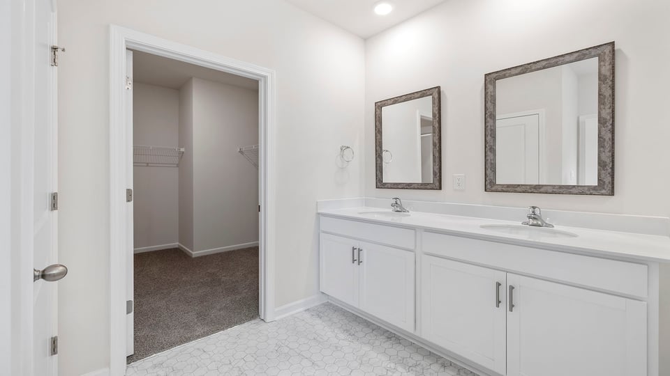 Bathroom with double vanity and walk in shower.