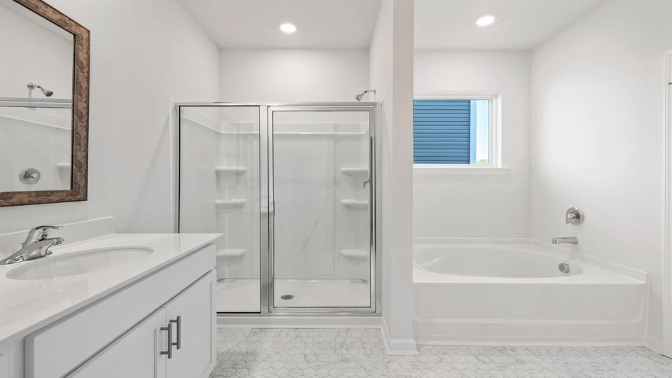 Bathroom with double vanity and walk in shower.