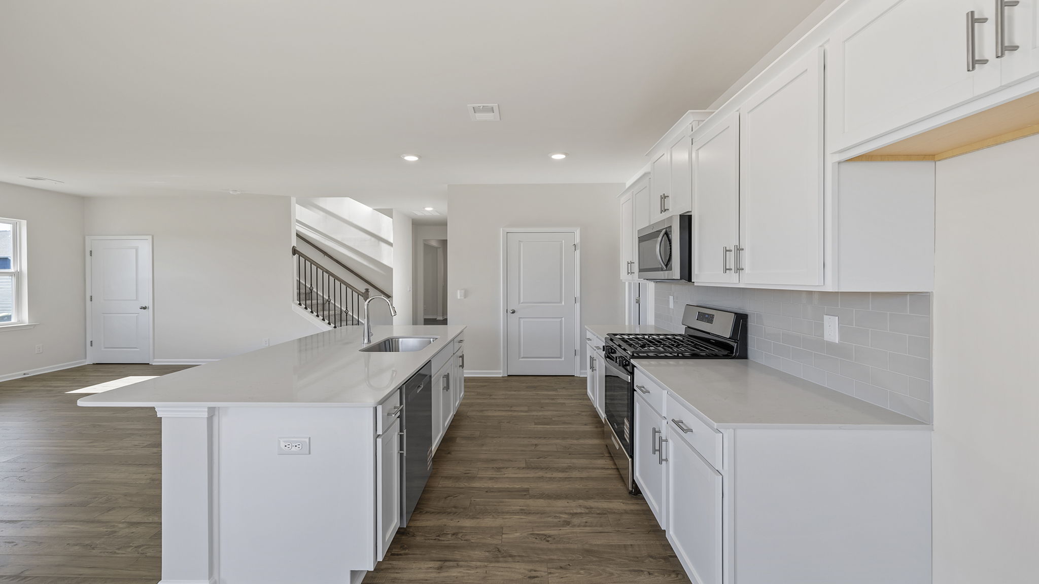 Kitchen and island with granite countertops.