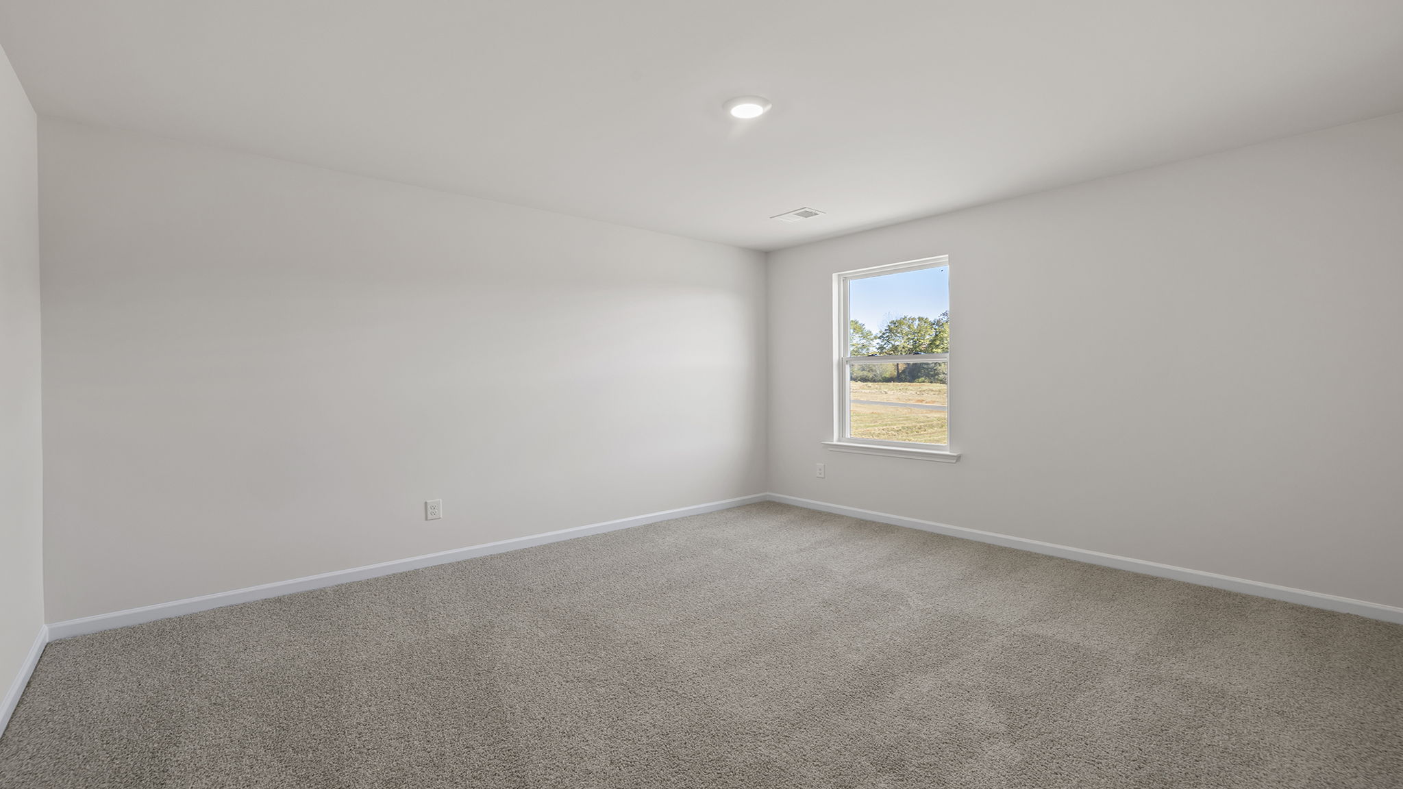 Bedroom with carpet and windows.