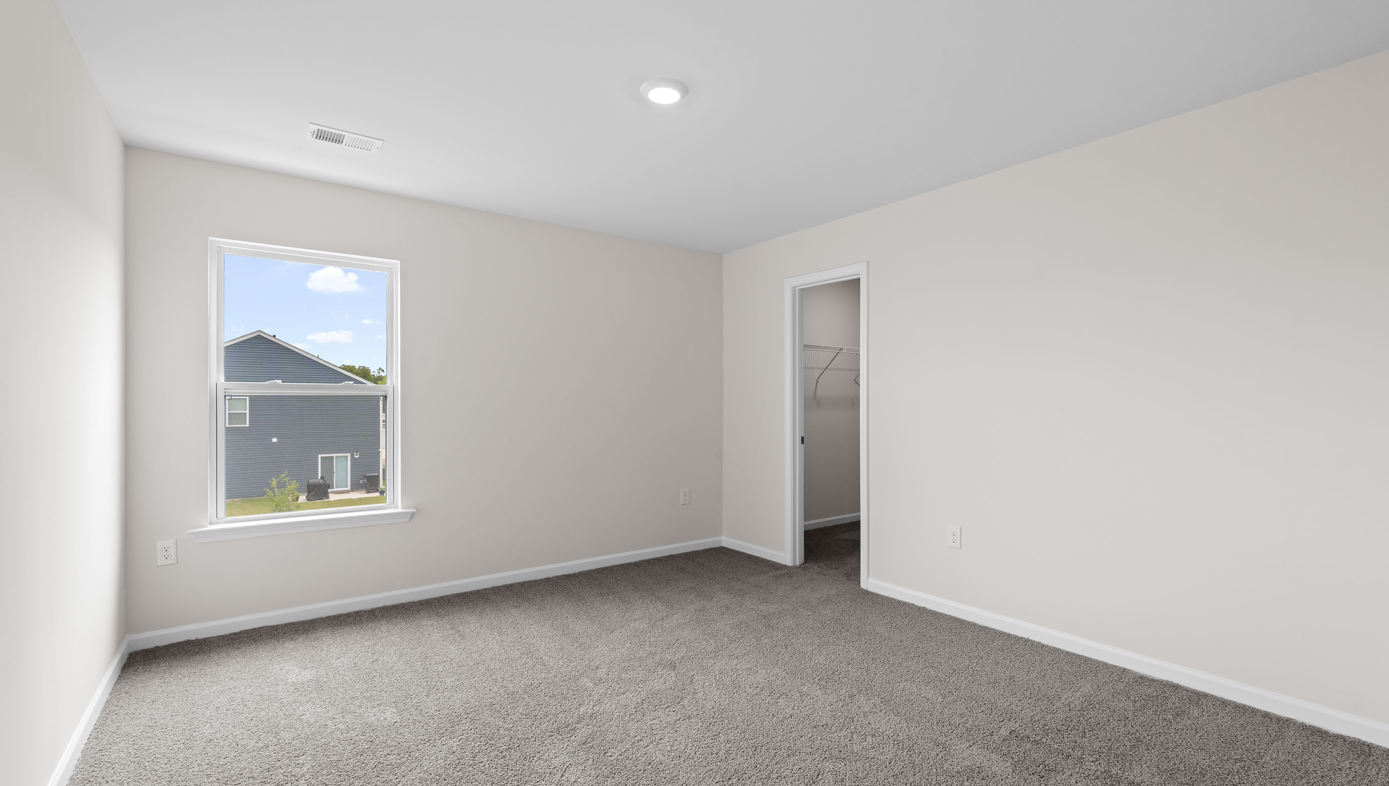Bedroom with carpet and windows.