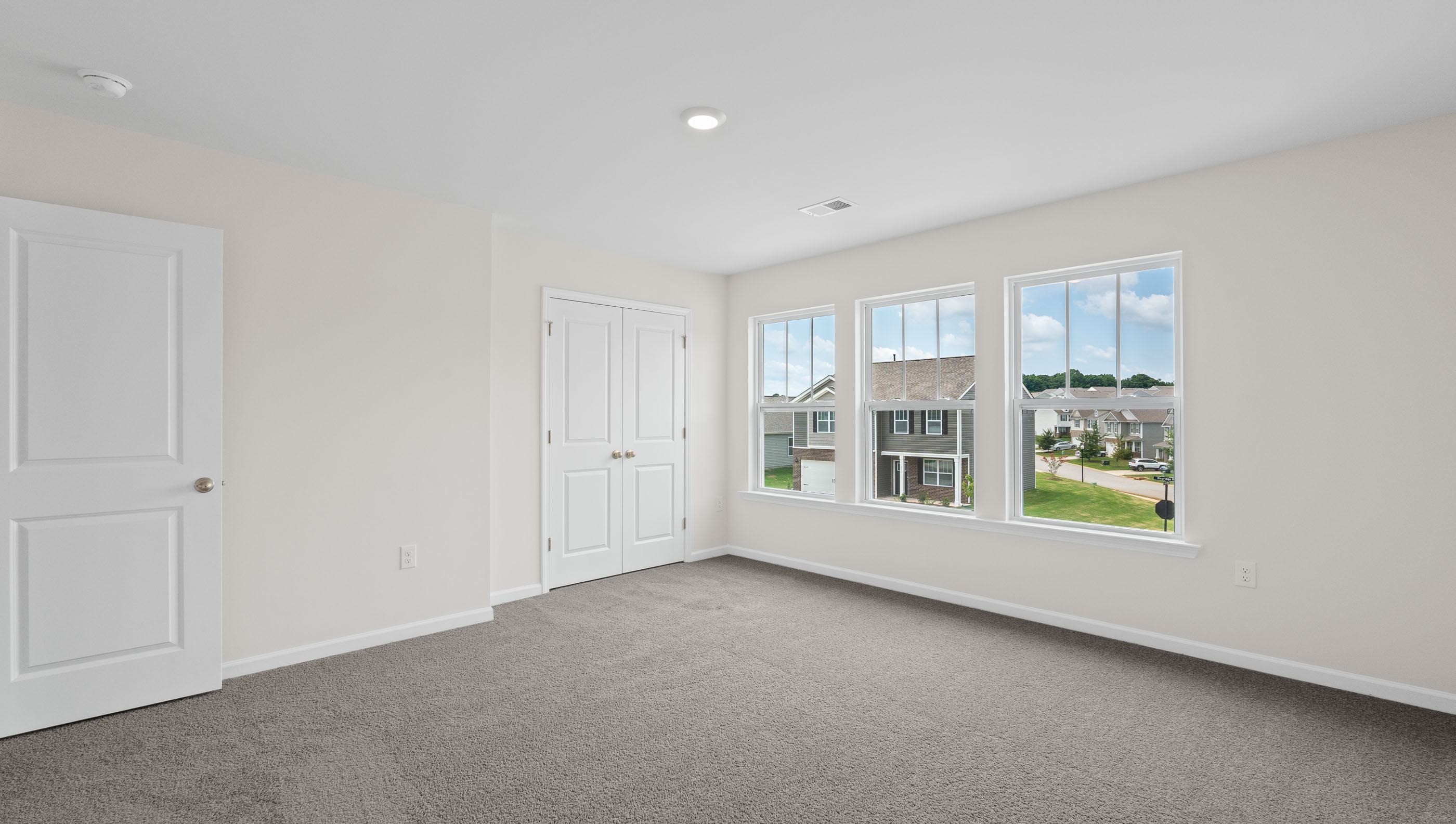 Bedroom with carpet and windows.