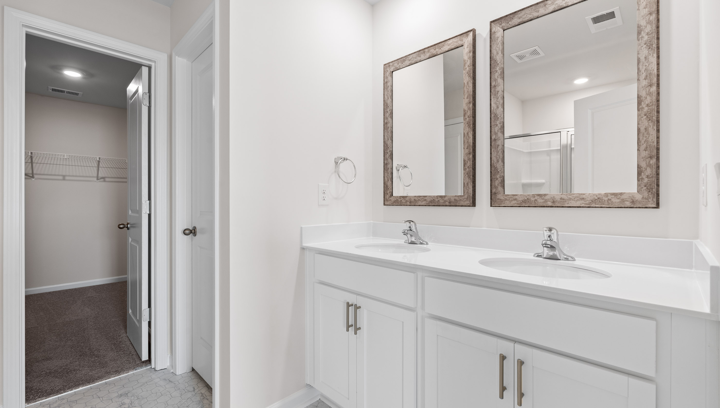 Bathroom with double vanity sink and wallk in shower.