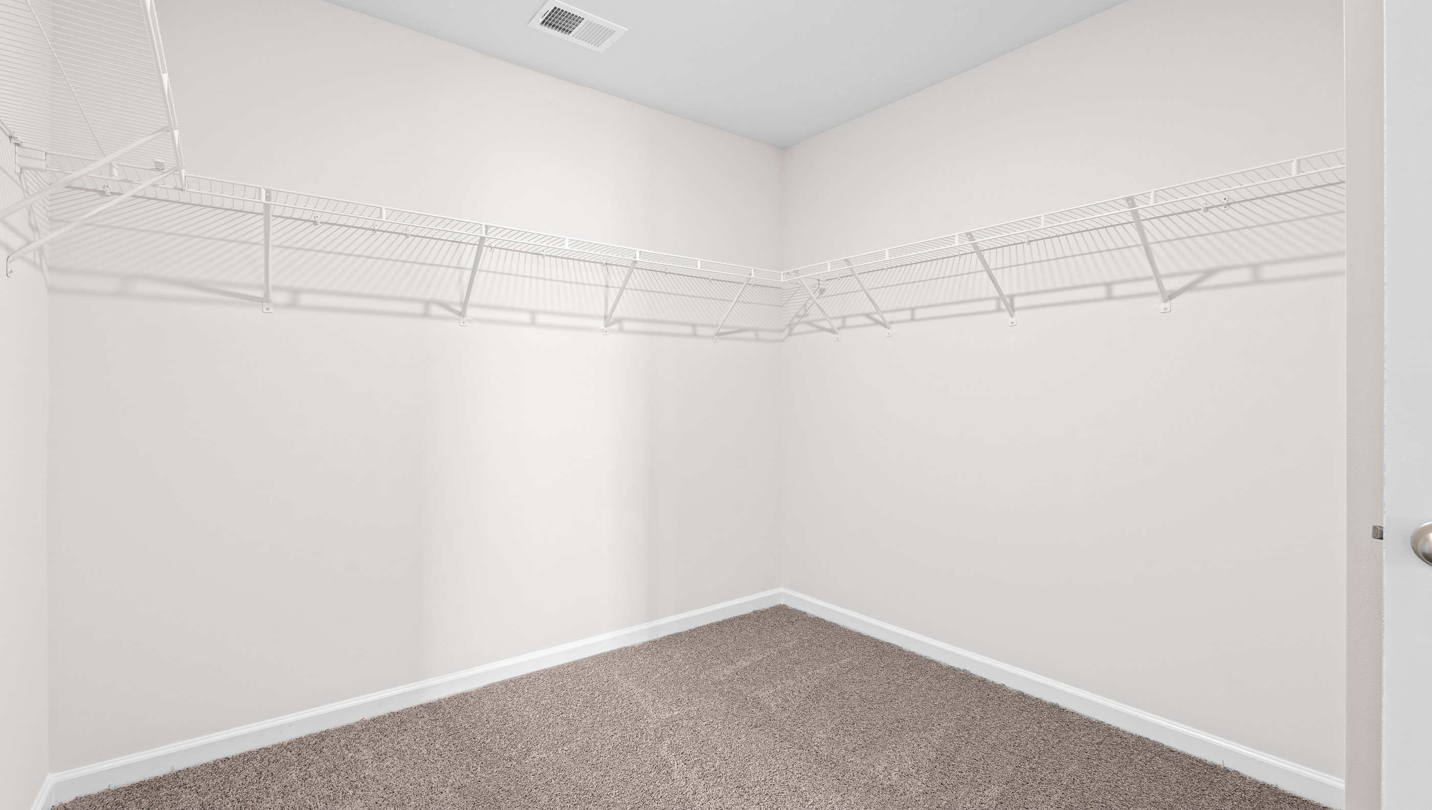 Closet with hanging storage shelves.