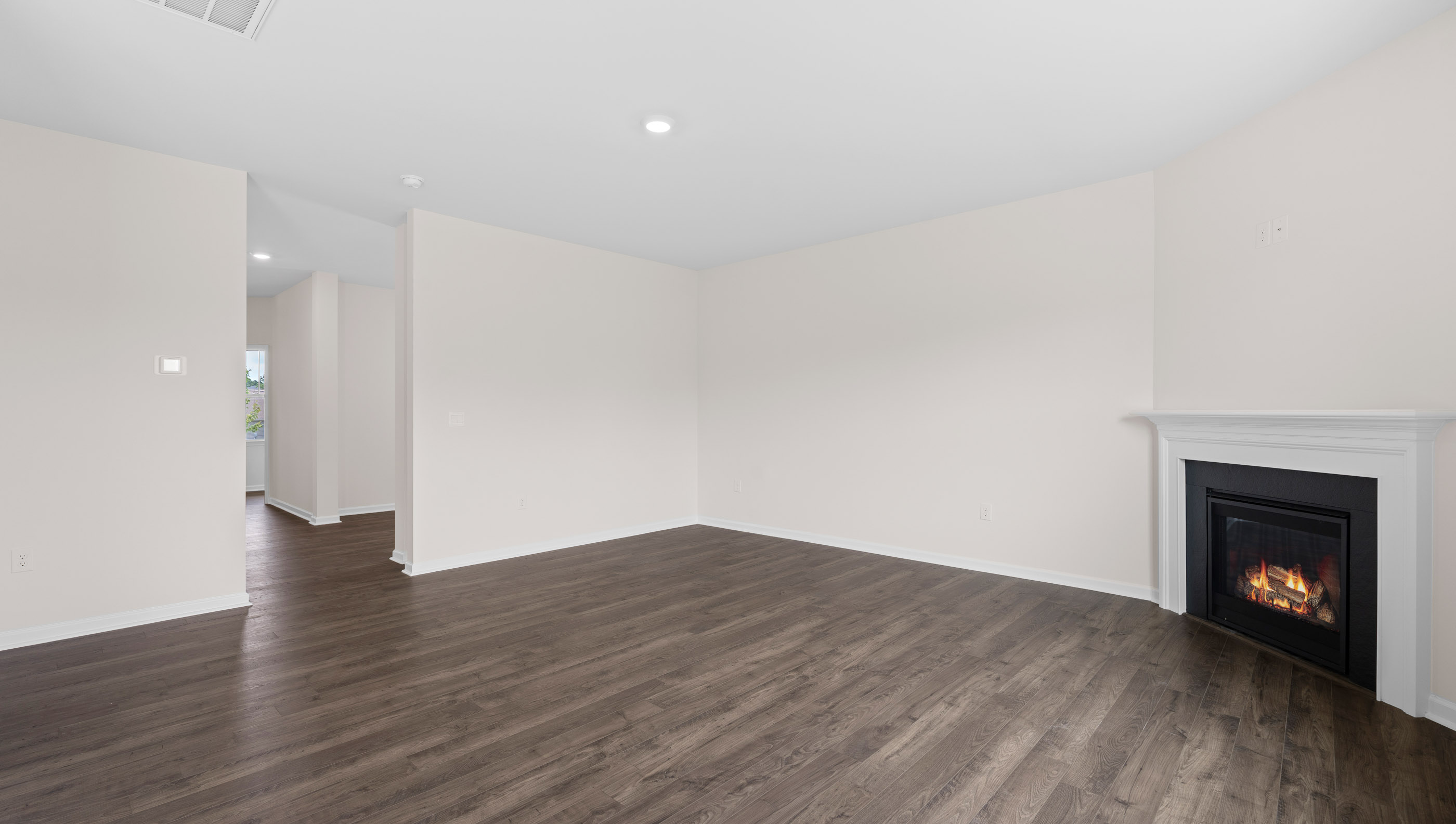 Family room with windows and fireplace.