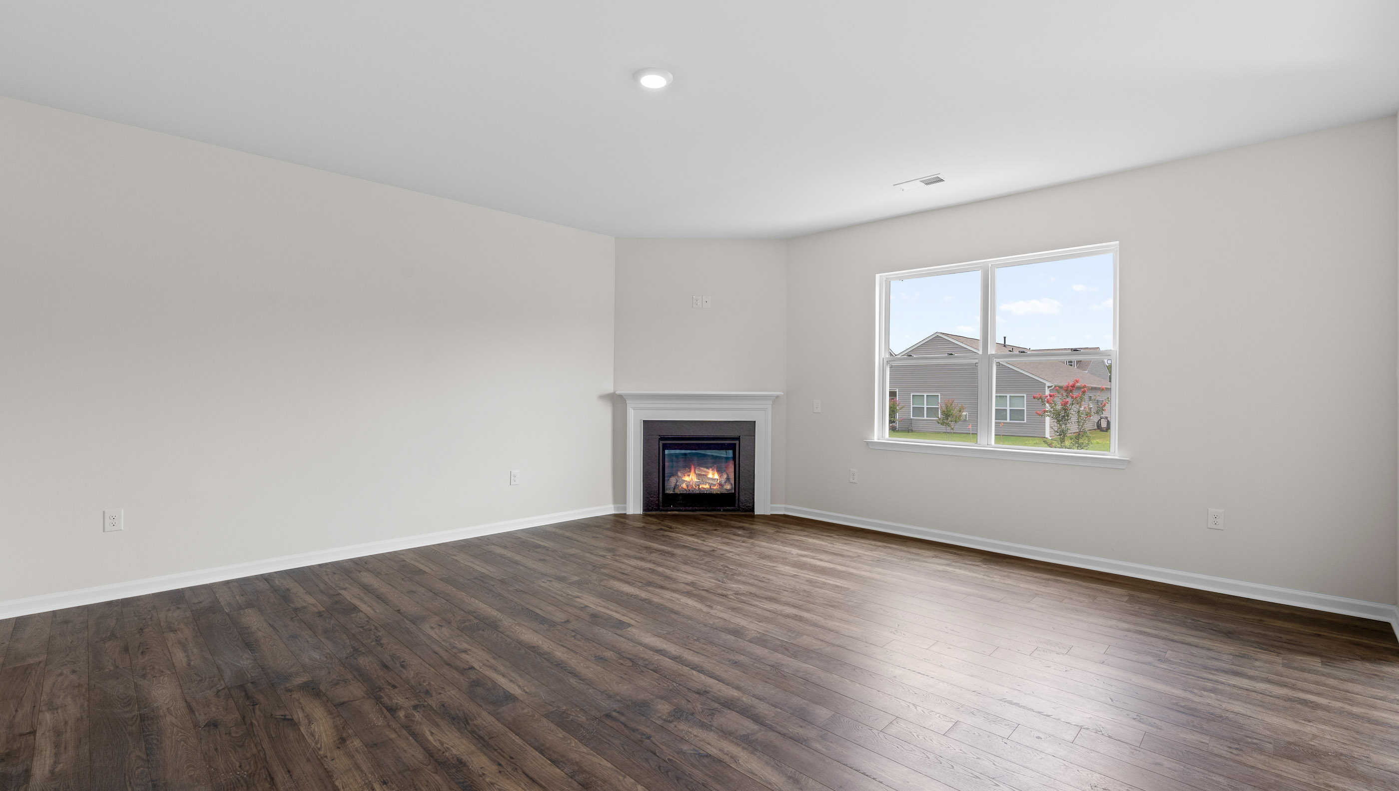 Family room with windows and fireplace.