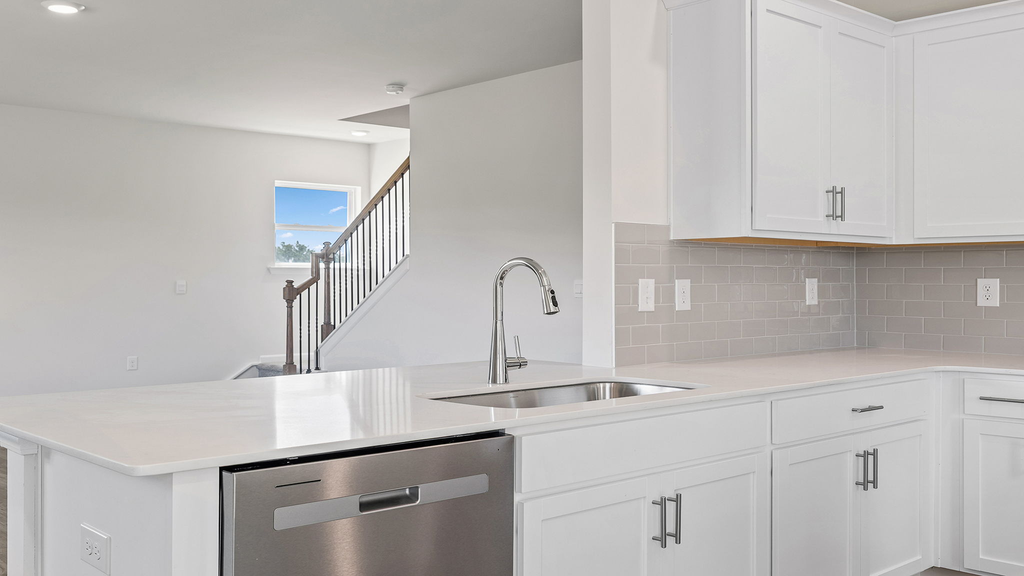 Kitchen with island and quartz countertop.