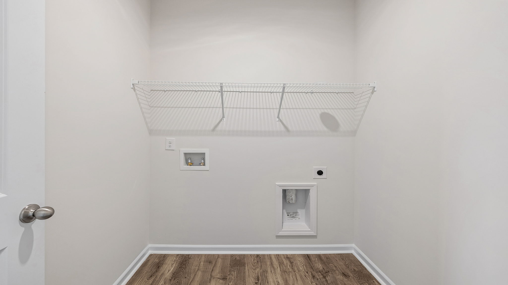 Walk in laundry with hanging shelves.