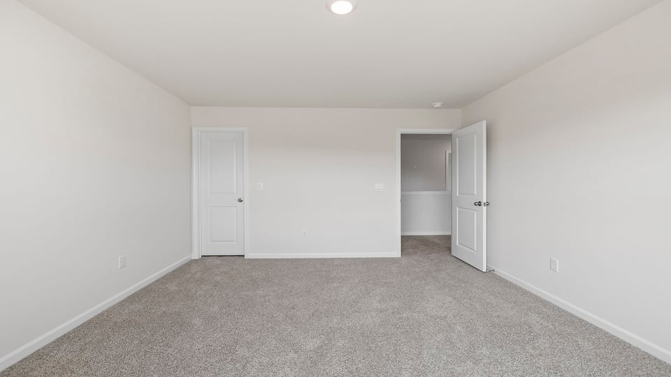 Bedroom with carpet and window.
