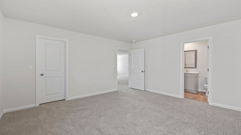 Bedroom with carpet and window.