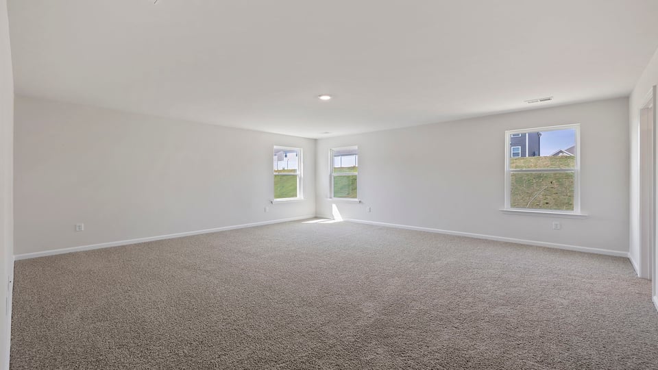 Bedroom with carpet and window.
