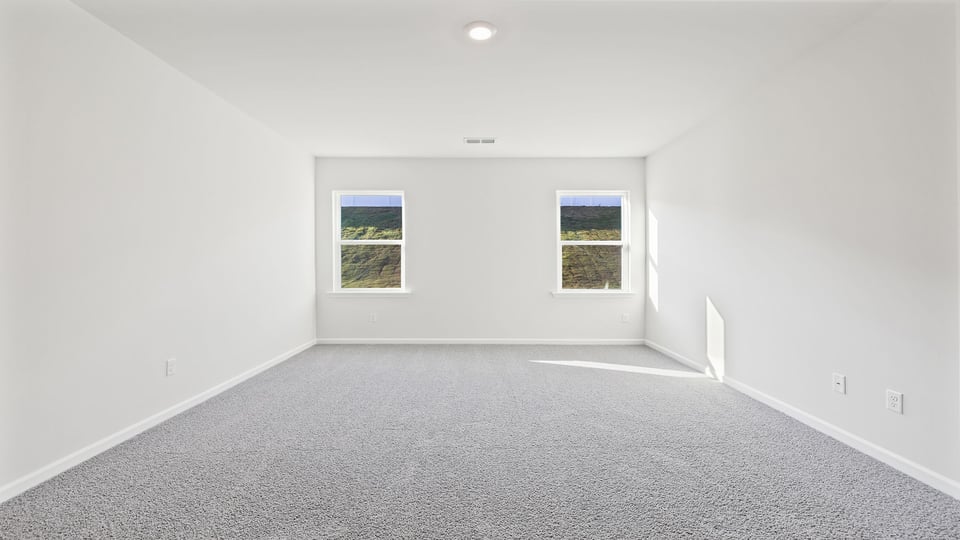 Bedroom with carpet and window.