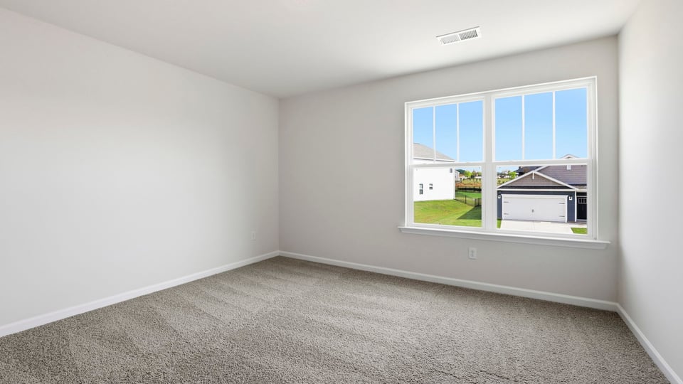 Bedroom with carpet and wiindow.